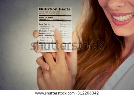 Closeup cropped portrait image woman reading healthy food nutrition facts isolated on gray wall background