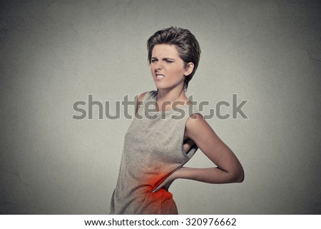 young woman with backache back pain back colored in red isolated on gray background