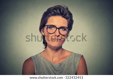 Skeptic. Doubtful upset angry woman in glasses looking at you camera isolated on gray wall background. Negative human emotion facial expression feeling body language attitude
