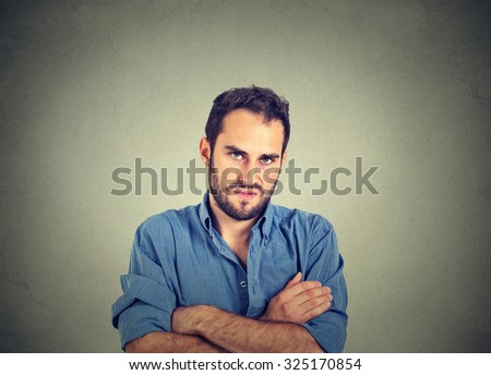 Closeup portrait of angry young man, about to have nervous breakdown, isolated on gray wall background. Negative human emotions facial expression feelings attitude