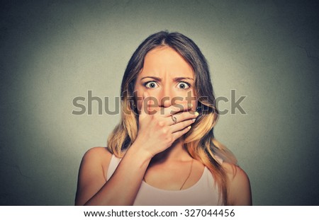 Closeup concerned scared shocked woman covering her mouth