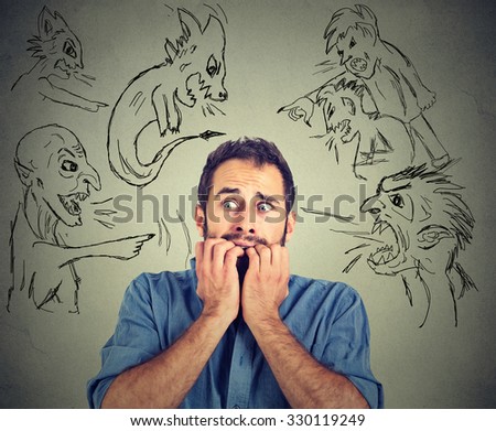 Bad evil men pointing at stressed man. Desperate scared young businessman isolated on grey office wall background. Negative human emotions face expression feelings life perception