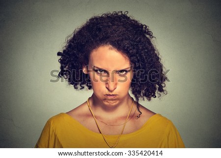 Closeup portrait of angry young woman, nervous, upset, about to have nervous atomic breakdown isolated on gray wall background. Negative human emotions facial expression feelings attitude