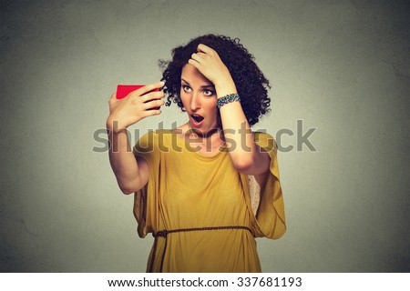 Closeup unhappy frustrated young woman surprised she is losing hair, receding hairline. Gray background. Human face expression emotion. Beauty hairstyle concept