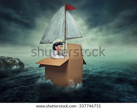 Woman traveling by water. Happiness freedom. Happy smiling young female captain entrepreneur. Designed imaginary vessel made from carton box