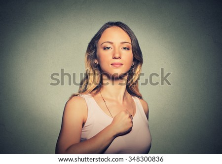 Superhero girl. Confident young woman isolated on gray wall background