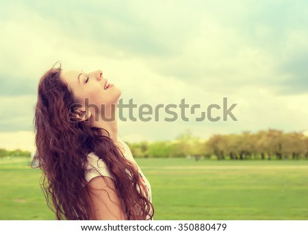 Side profile woman smiling looking up to blue sky celebrating enjoying freedom. Positive human emotion face expression feeling life perception success, peace of mind concept. Free happy girl