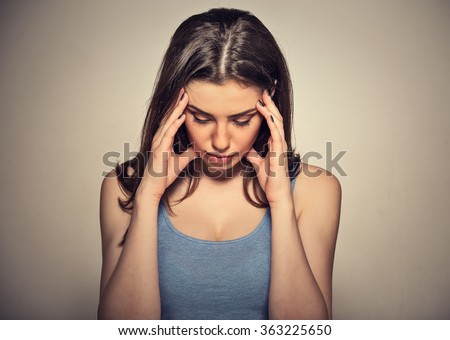 Closeup portrait sad young beautiful woman with worried stressed face expression looking down