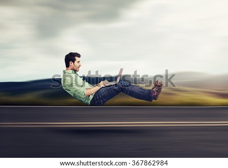 Fast internet concept. Autonomous self driving vehicle car technology. Levitating business man on road using laptop