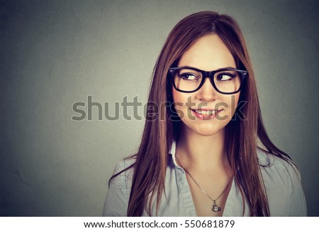 Excited woman looking sideways smiling. Closeup of happy mixed race female business woman isolated on gray background
