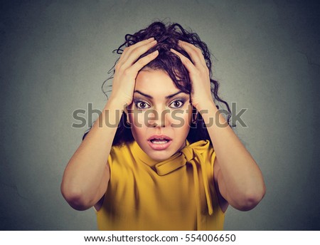 Desperate stressed worried young woman with hands on head