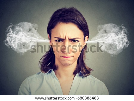 Closeup portrait of angry young woman, blowing steam coming out of ears isolated gray background. Negative human emotions facial expression feelings