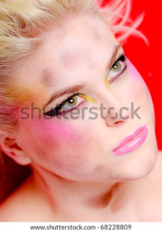 Closeup portrait of an angry model wearing messy makeup