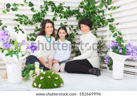 Cute little girl, her mother and grandmother together on this portrait