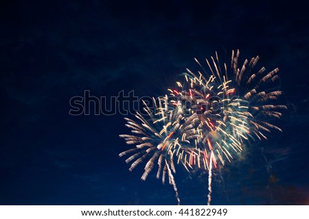 Fireworks light up the sky with dazzling display. Fireworks display on dark sky background. Independence Day, 4th of July, Fourth of July or New Year.