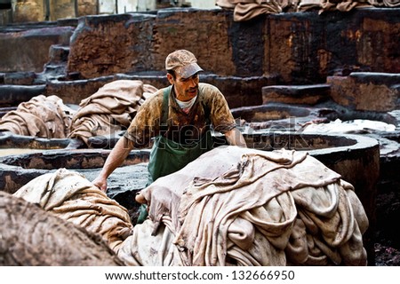 FES, MOROCCO - MARCH 4: Workers at leather factory perform the work on March 4, 2013. Tanning production is one of the most ancient in Morocco