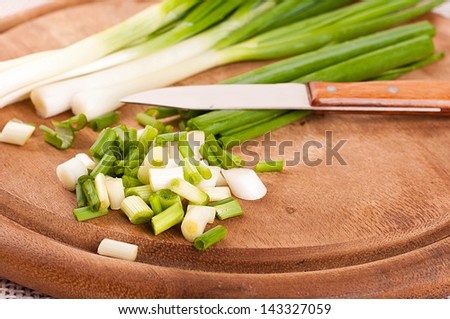 Green onions cut on a wooden board