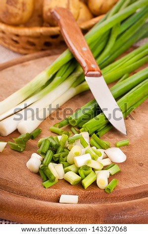 Green onions cut on a wooden board