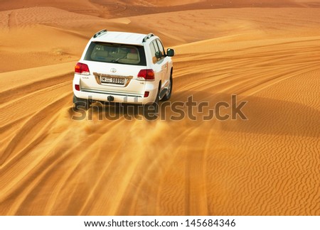 Dubai - June 2: Driving On Jeeps On The Desert, Traditional Entertainment For Tourists On June 2, 2013 In Dubai