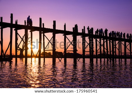 Bridge U-Bein teak bridge is the longest. Sunset with silhouettes of people unrecognizable