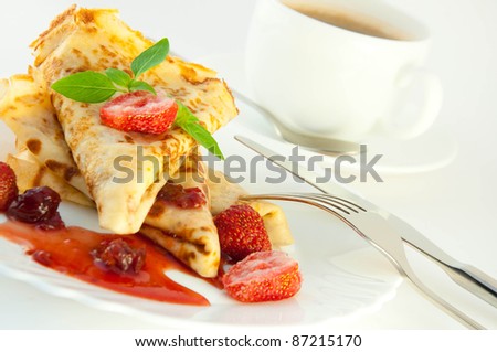 Fritters with strawberry jam and mint and a cup of coffee