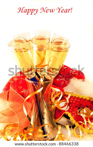 Christmas card. Glasses with champagne and a New Year\'s mask, a carnival