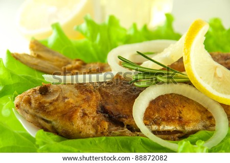 Fish fried, a crucian with a lemon, rosemary and olive oil