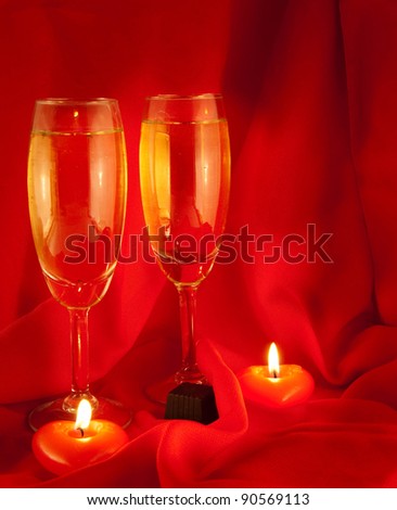 Celebratory table layout with red napkins and candles in the form of heart