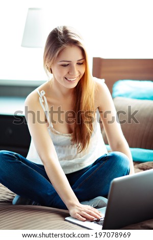 Young woman surfing the net at home