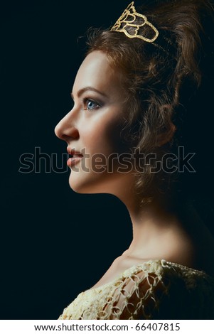 Profile of majestic young woman wearing tiara on black background