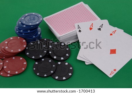 a deck of cards and casino chips on a green table