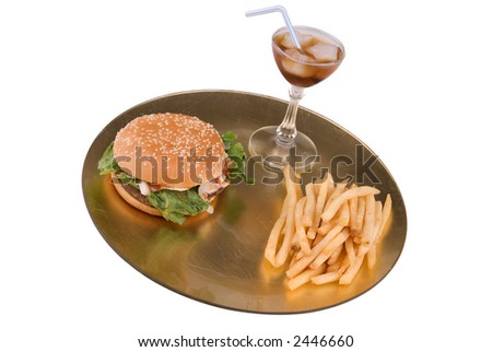 gourmet Hamburger and fries on a decorative gold plate with a fancy soda on white background