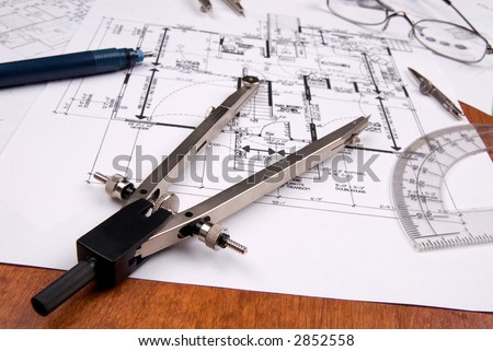 engineer, architect or contractor plans and tools laid out on a wooden table