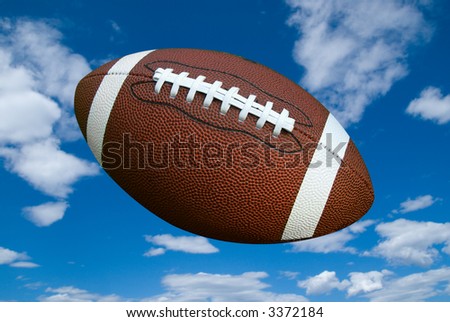 American football isolated over a cloudy sky background