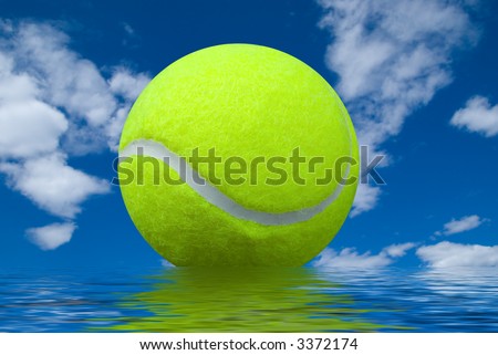 tennis ball isolated over a cloudy sky background with water reflection