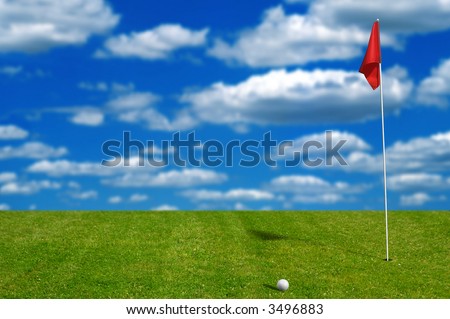 Golf ball on the putting green with sky and clouds in the background