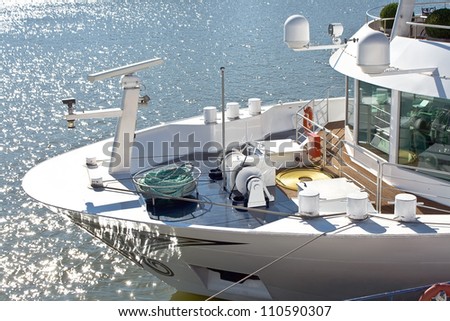 Bow and deck of the ship beside glistening water