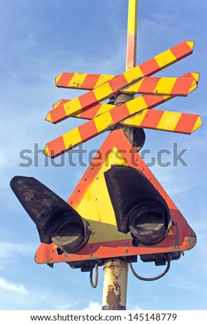 Railway sign and traffic lights at a railroad crossing