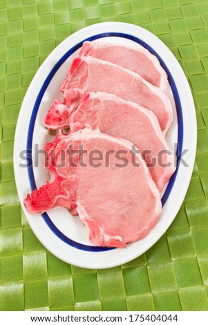 Pork chop meat on white plate