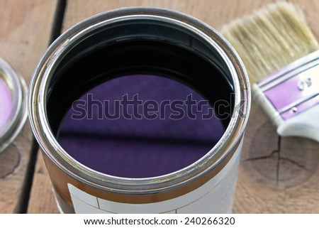 Varnish can paint brush and  on wooden background