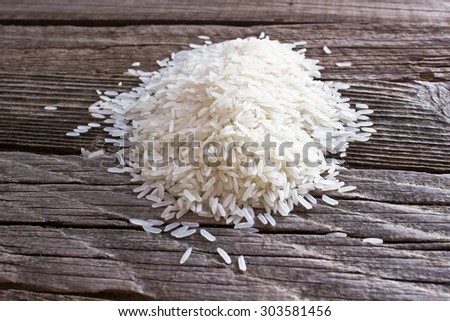 Pile of rice on wooden background