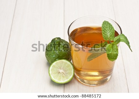Glass of lime juice and lime fruits