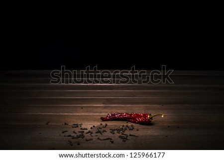 spices black pepper, carnation and red hot pepper on a wooden table