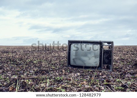 old broken TV is an autumn field