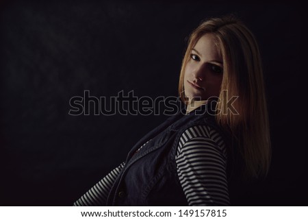 portrait of beautiful thoughtful girl close up in the dark