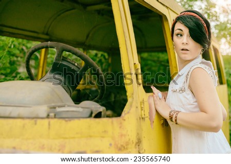 young woman the hipster tries to steal old a retro car bus but is afraid