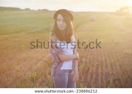 young beautiful free sad woman hipster in fall field