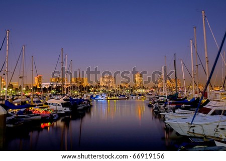 Night Harbor View of Sail Boats and Distant High Riser