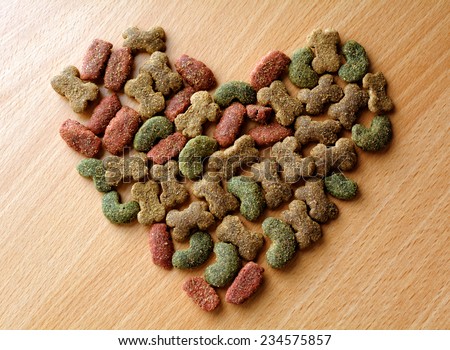 Dry dog food in heart shape on the table