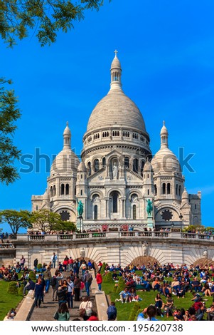 PARIS - MAY 4: Many people in the Sunday rest on the grass in front of the Basilica of the Sacred Heart of Jesus at the butte Montmartre of Paris on 4 may 2014.